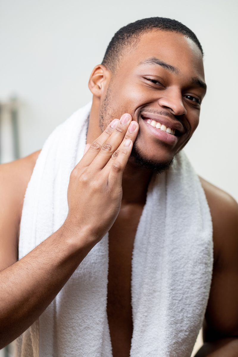beard care facial treatment man touching face skin