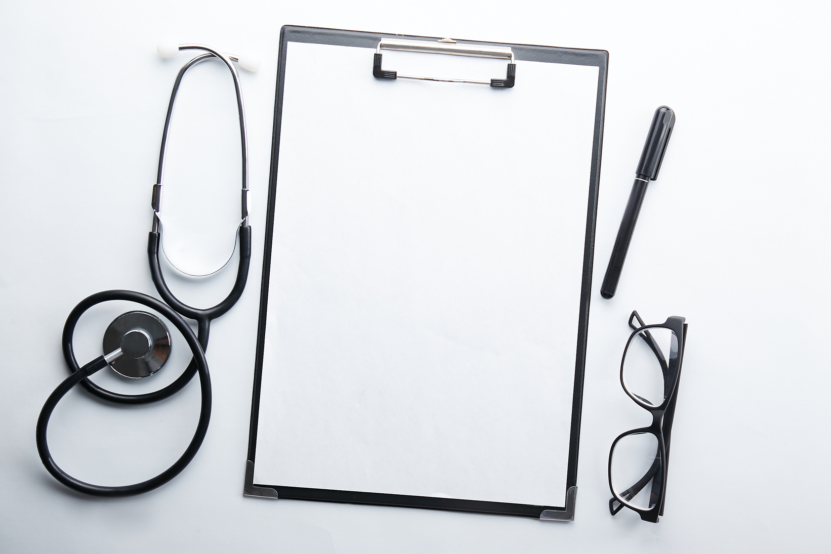 Medical equipment and technology concept. Case history and stethoscope.